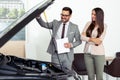 Sales manager at a showroom car is worth to the buyer Royalty Free Stock Photo