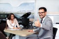 Sales manager at a showroom car is worth to the buyer Royalty Free Stock Photo