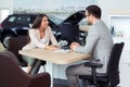 Sales manager at a showroom car is worth to the buyer Royalty Free Stock Photo