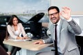 Sales manager at a showroom car is worth to the buyer Royalty Free Stock Photo