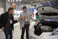 Sales manager telling journalist about new electric car