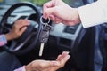 The sales representative is giving the car keys to the new owner in the car. Ideas for renting a car or buying a car Royalty Free Stock Photo