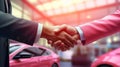 A sales representative shaking hands with an individual over a car, in the style of light crimson, poster, large canvas Royalty Free Stock Photo