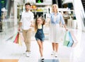 Family Of Three Carrying Shopper Bags After Shopping In Mall Royalty Free Stock Photo