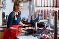 Sales woman in butcher shop putting different kinds of meat in display Royalty Free Stock Photo