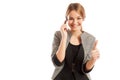 Sales woman talking on the phone and showing thumbs-up Royalty Free Stock Photo