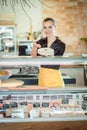 Salesgirl selling cheese in deli or supermarket Royalty Free Stock Photo