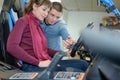 Salesman explaining controls buggy to woman