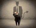 Salesman facing his own devil shadow Royalty Free Stock Photo