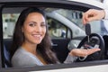 Salesman giving keys to a smiling woman Royalty Free Stock Photo