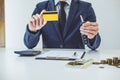 Salesman holding a key, credit card and calculating a price of s Royalty Free Stock Photo