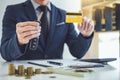 Salesman holding a key, credit card and calculating a price of s Royalty Free Stock Photo