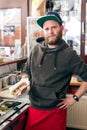 Salesman making hotdog in fast food snack bar Royalty Free Stock Photo