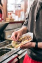 Salesman making hotdog in fast food snack bar Royalty Free Stock Photo