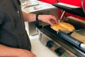 Salesman making hotdog in fast food snack bar Royalty Free Stock Photo