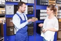 Salesman offering door lock to woman Royalty Free Stock Photo