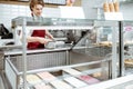 Salesman putting ice cream into the refrigerator