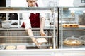 Salesman putting ice cream into the refrigerator