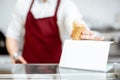 Salesman putting ice cream on the showacse