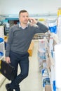 salesman in retail outlet talking on smartphone Royalty Free Stock Photo