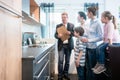 Salesman showing family the features of a new kitchen Royalty Free Stock Photo