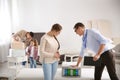 Salesman showing young woman section of mattress