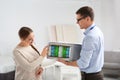 Salesman showing young woman section of mattress