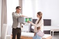 Salesman showing young woman section of mattress