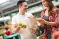 Salesman and young woman looking at market Royalty Free Stock Photo