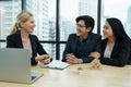 Salesmen are letting the male customers sign the sales contract, caucasian women and couple are doing business in the office,