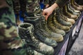 salesperson arranging combat boots on display