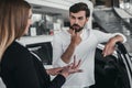 Salesperson with customer in car dealership Royalty Free Stock Photo