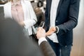 Giving a car keys to a couple in the showroom Royalty Free Stock Photo
