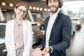 Happy couple buying a new car in the showroom Royalty Free Stock Photo