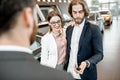 Happy couple buying a new car in the showroom Royalty Free Stock Photo