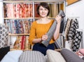 Saleswoman arranging fabric bolts