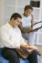 Saleswoman Assisting Man In Selecting Fabrics At Store