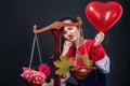 Saleswoman of beautiful autumn mood with colorful maple leaves, flowers and a heart shaped balloon