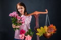 Saleswoman of beautiful autumn mood holds out a bouquet of chrysanthemum flowers