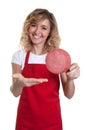 Saleswoman with blond hair presenting italian salami