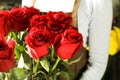 Saleswoman holding bouquet of beautiful roses, closeup