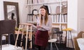 Saleswoman offering bar stools in furniture store