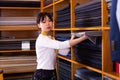 Saleswoman offering cloth in textile shop