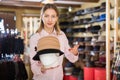 Saleswoman offering hats in headwear shop