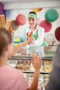 Saleswoman in pastry store gives ice cream to girl Royalty Free Stock Photo