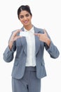 Saleswoman pointing at blank business card Royalty Free Stock Photo