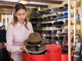 Saleswoman preparing hats in boxes for sale