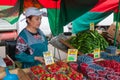 The saleswoman selling berries in Vegetable Fair