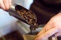 Saleswoman selling bulk coffee at an organic store.