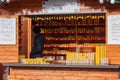 Saleswoman in stall with bee candles at Christmas market on the Cabbage Market on November26, 2023 Brno, Czech Republic